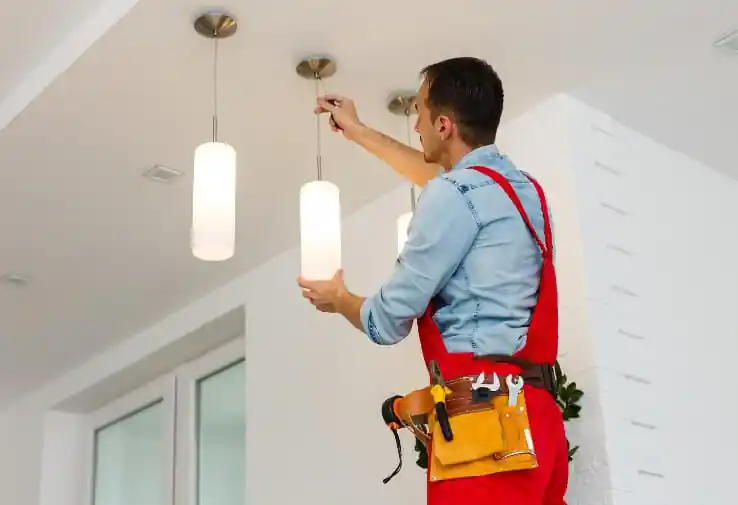 electrician-putting-up-light-fixtures