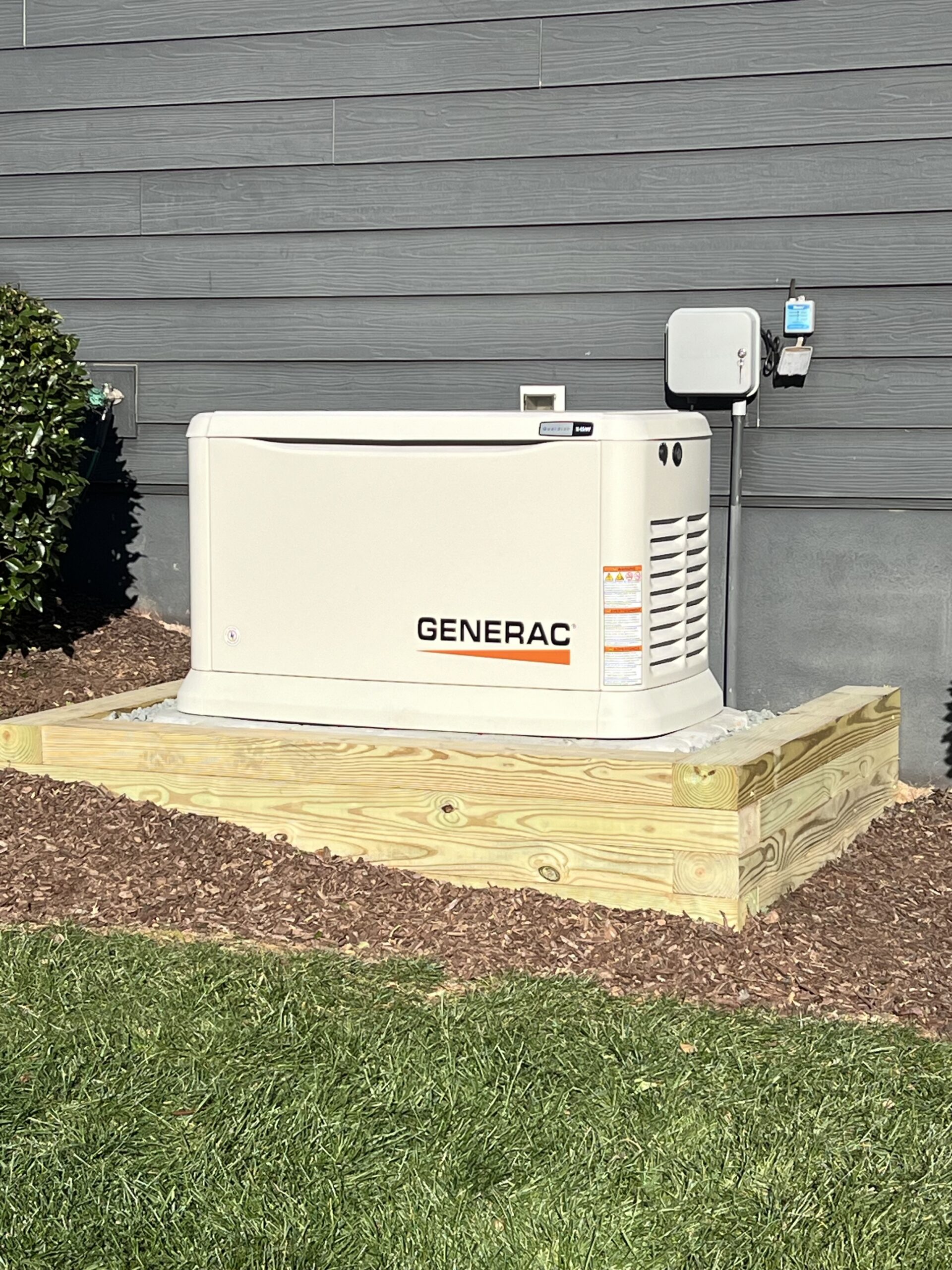 Generac standby generator installation on residential home exterior, providing whole-house backup power.