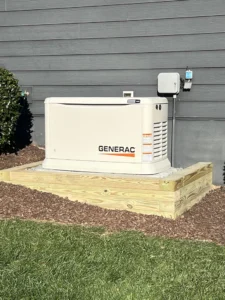 Home generator installed on wooden platform beside a house